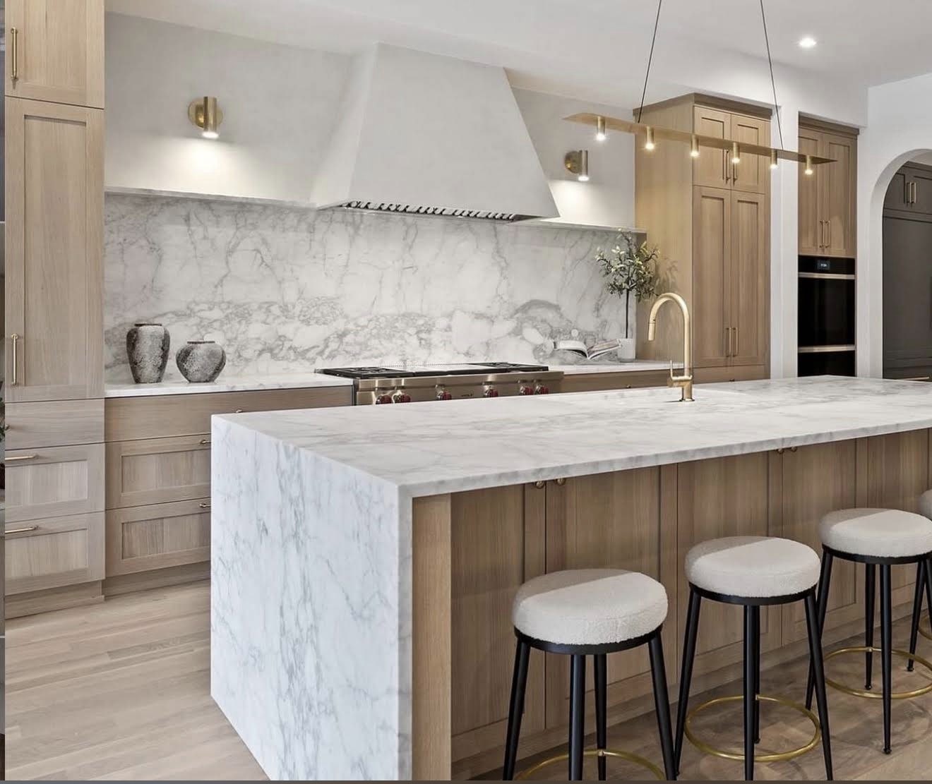 Marble waterfall island with brass fixtures, Newport Beach, CA