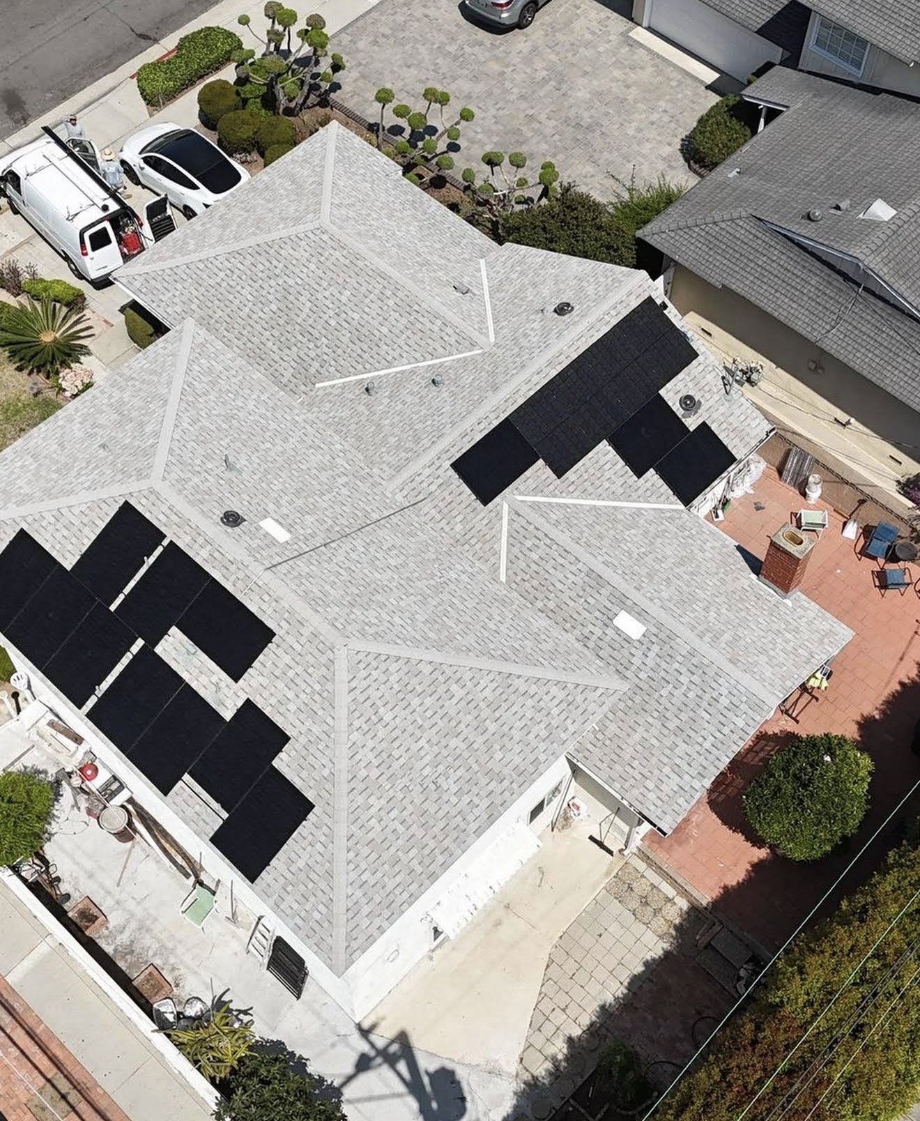 Aerial view of a completed shingle roof with a solar array, Santa Ana, CA